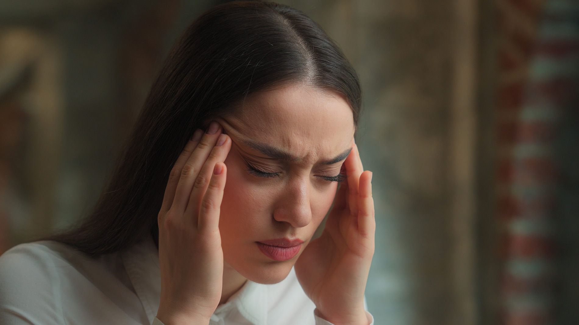 woman holding her head