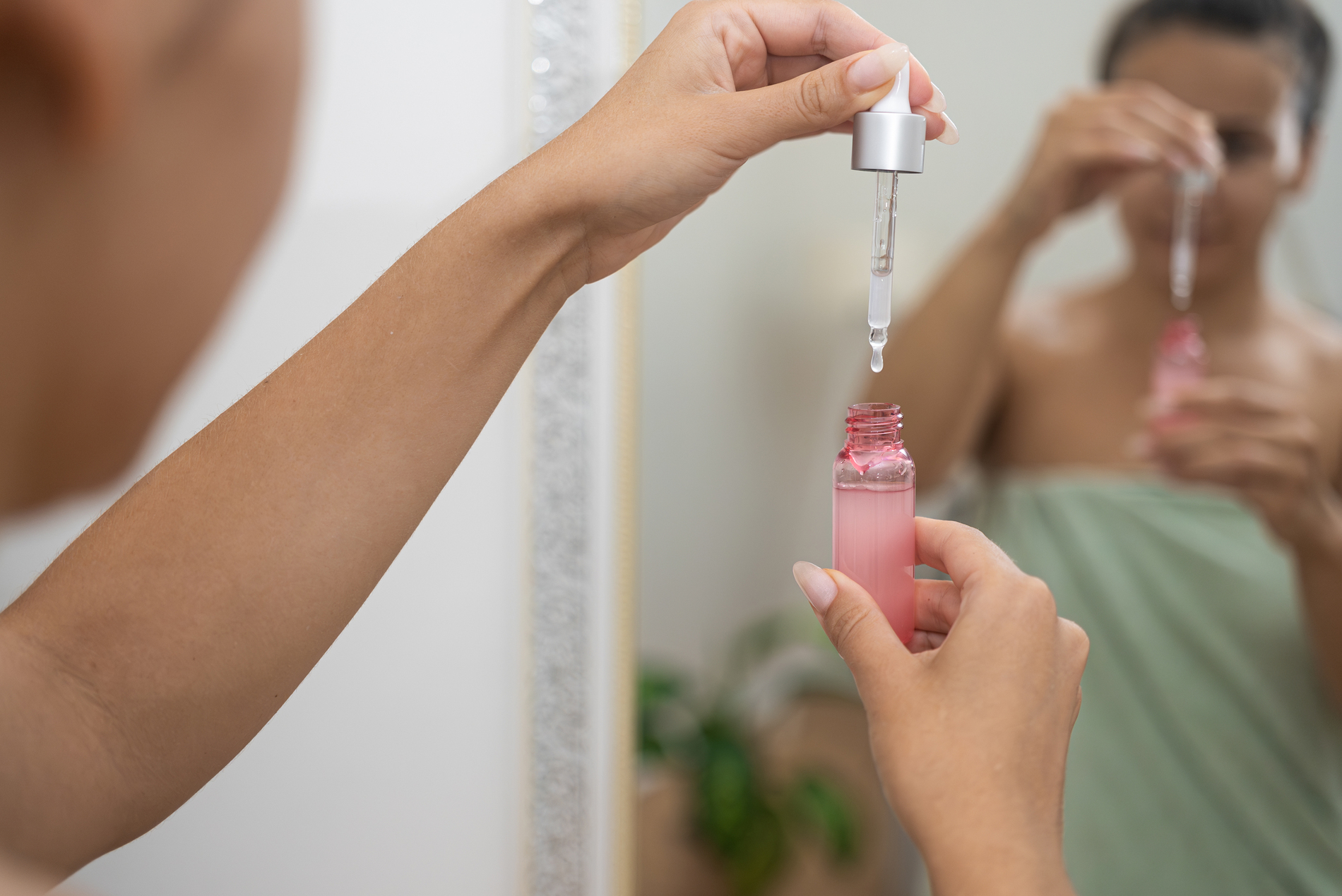 Woman applying hyaluronic acid serum