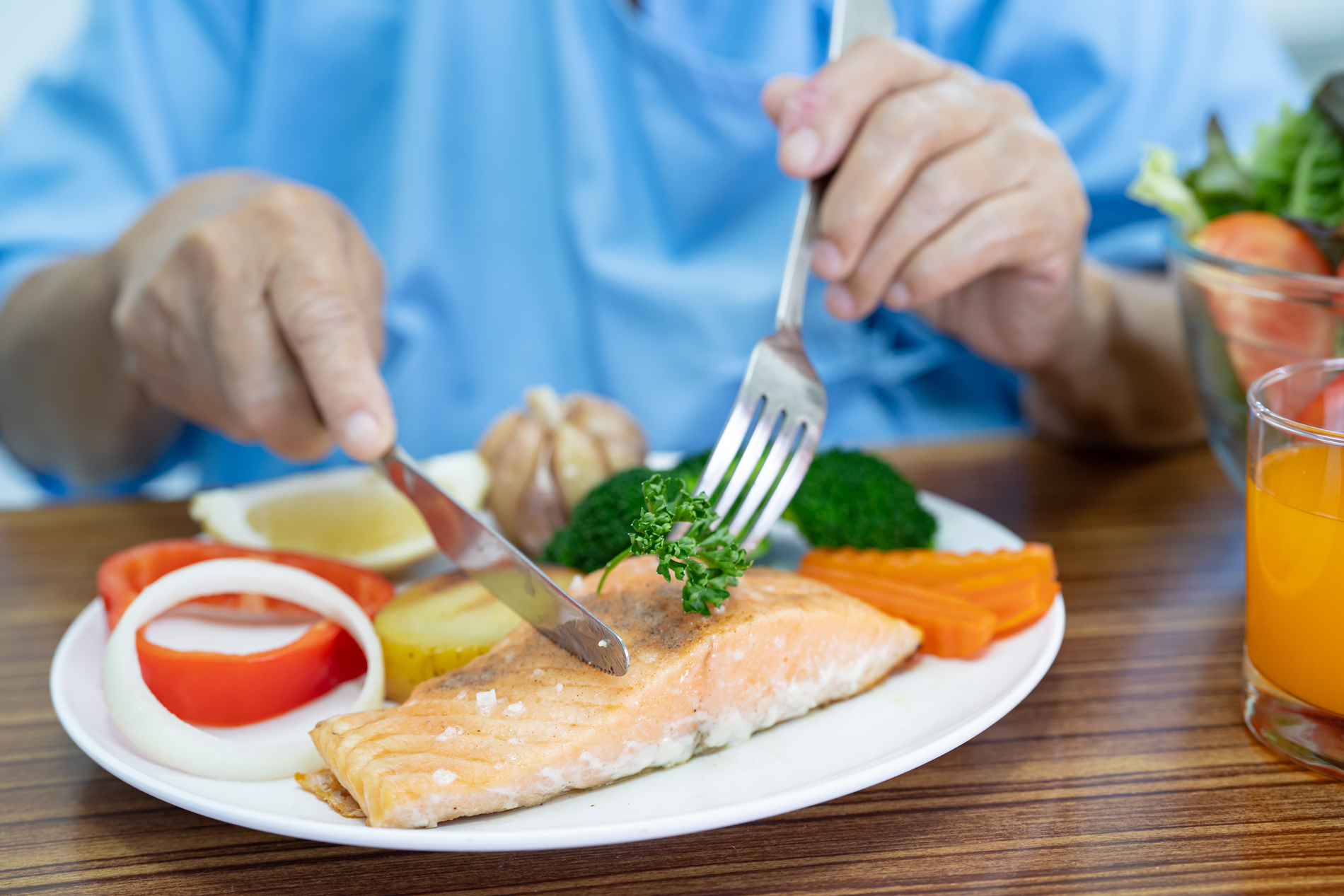 Person eating salmon steak