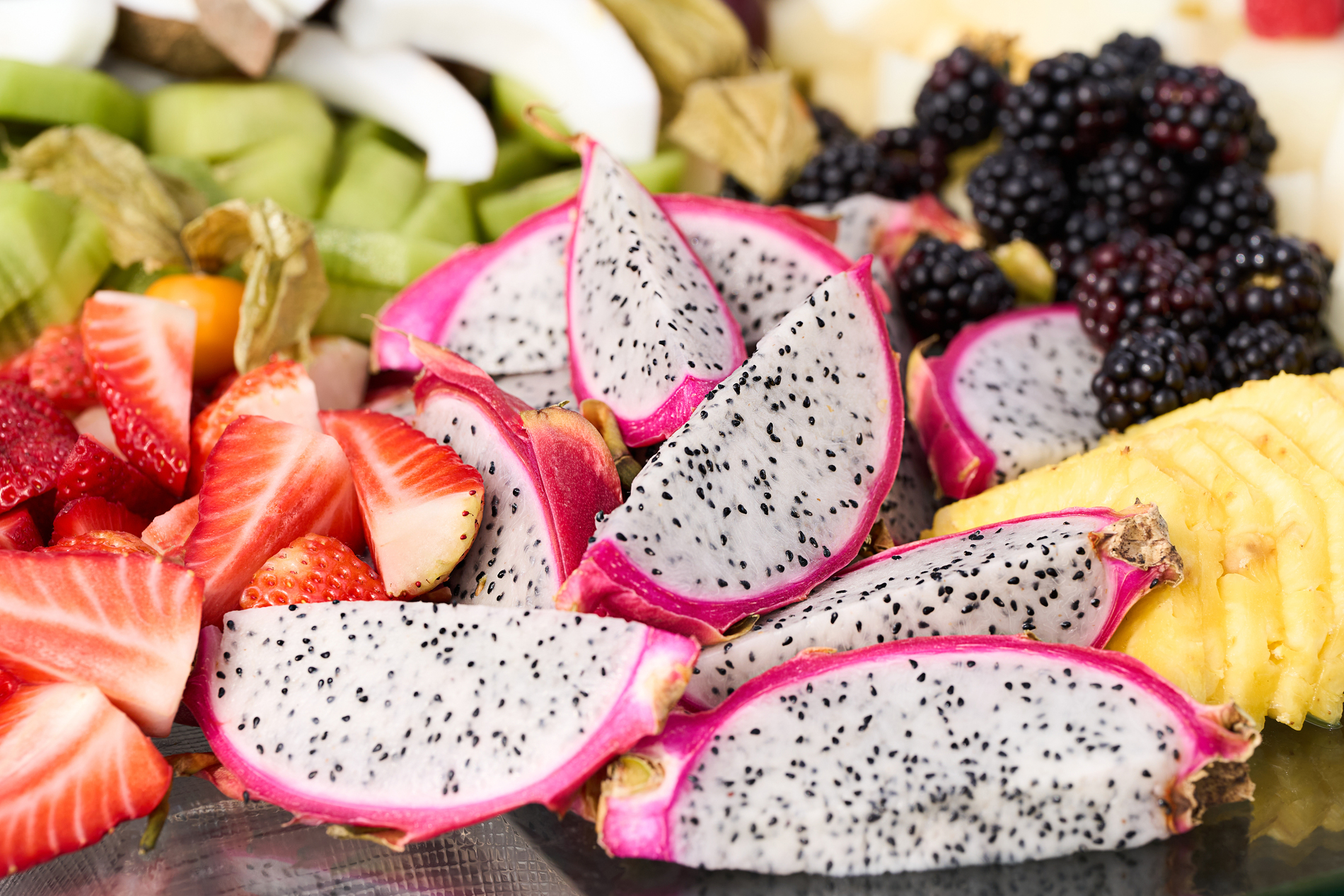 Assorted fresh fruits including strawberries, kiwi and grapes