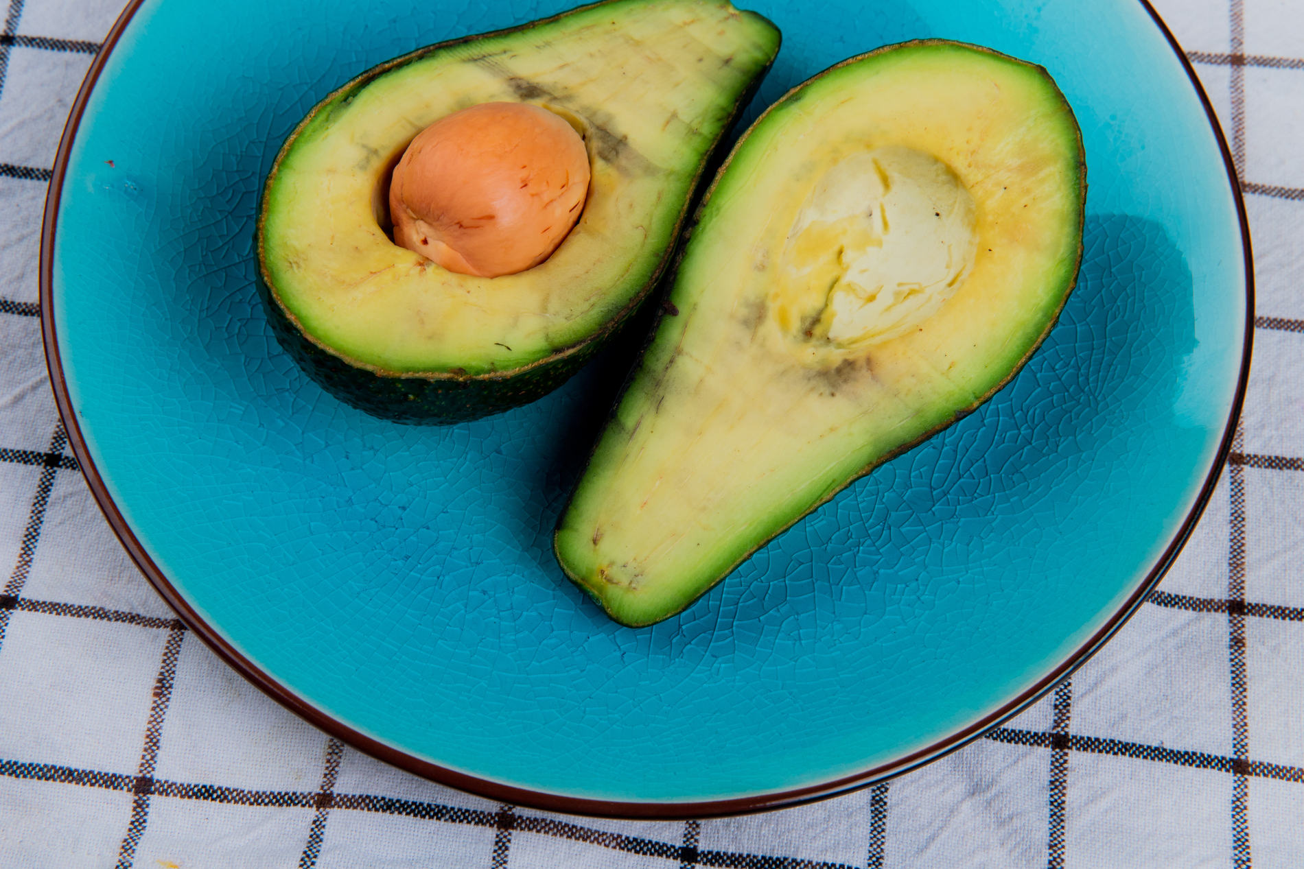 Half-cut avocado on plate