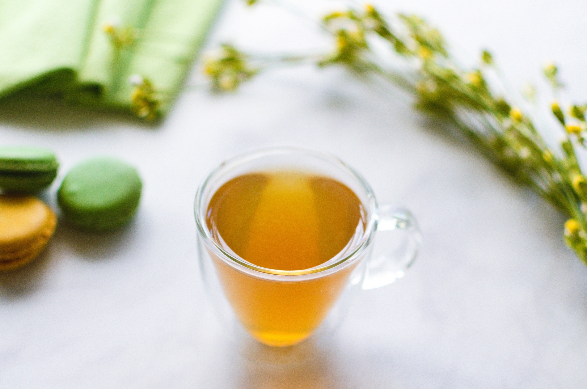 Cup of green tea with macarons