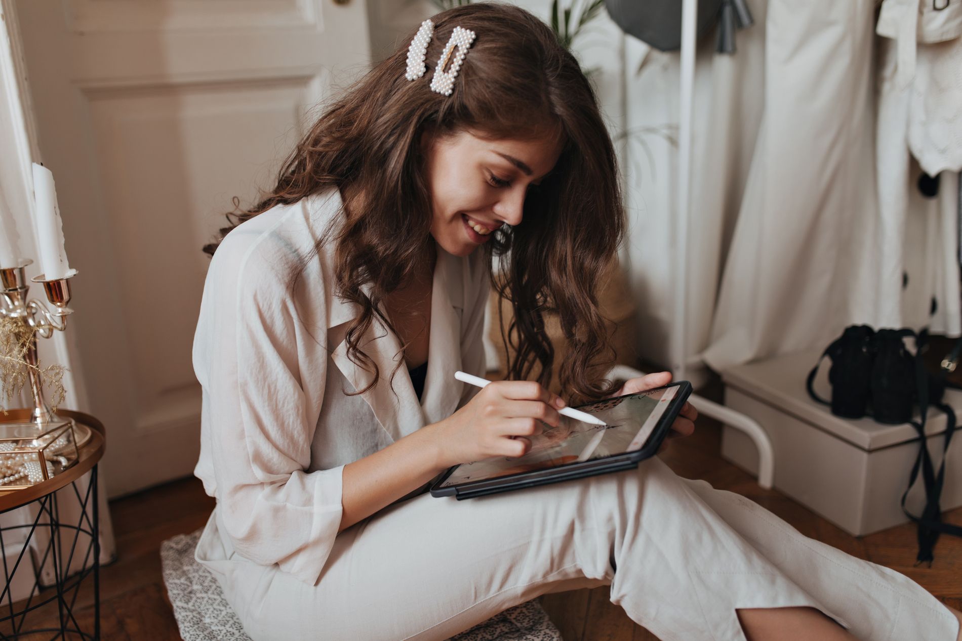 woman smiling and writing in a notebook