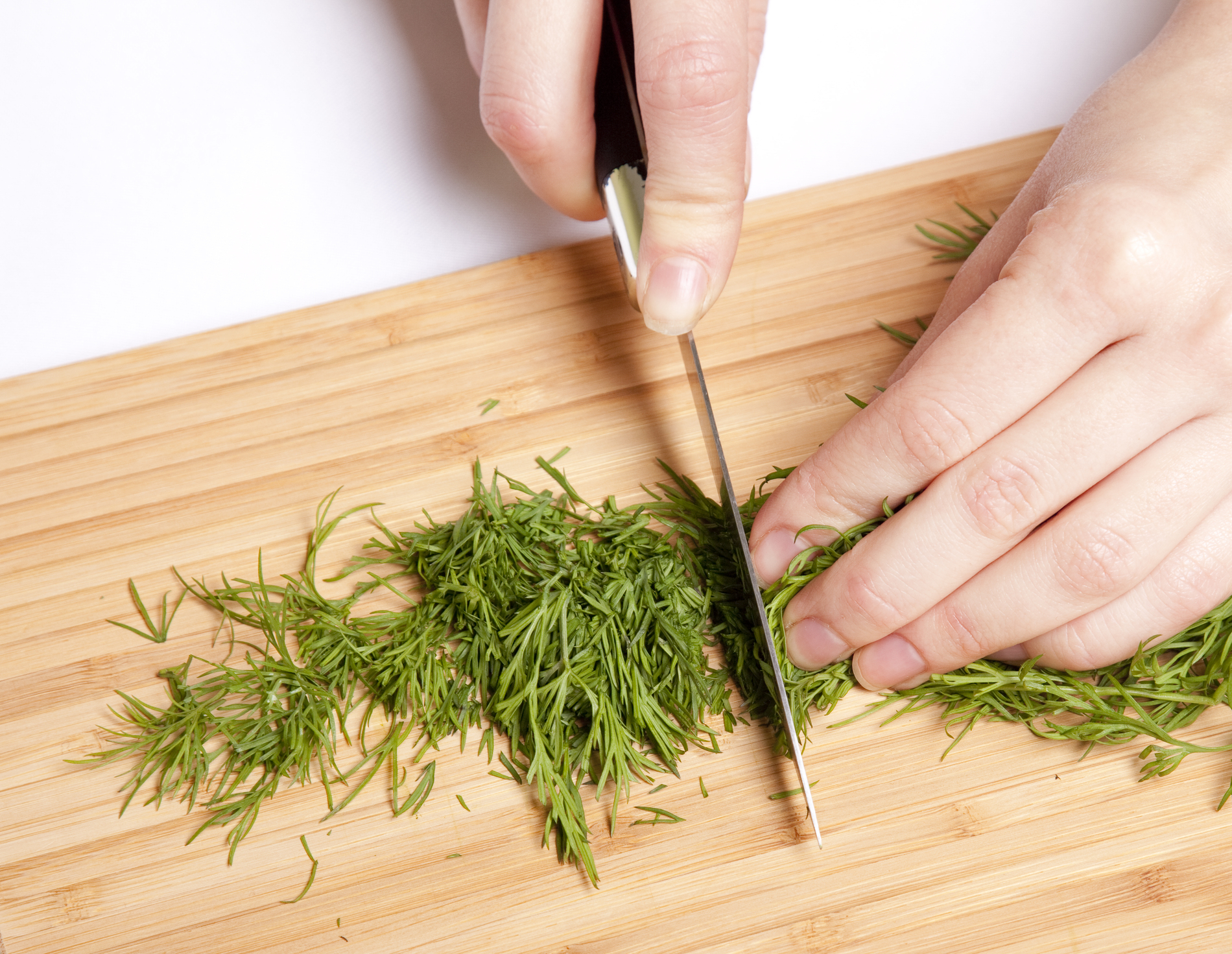 Fresh dill being cut