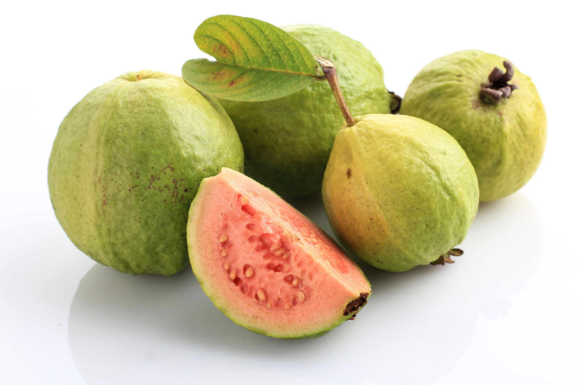 Sliced pink guava with leaves
