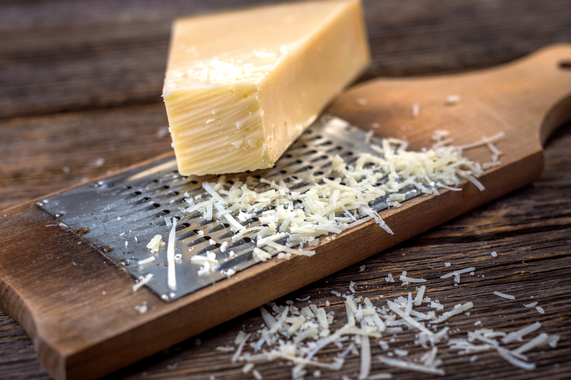 Grated parmesan cheese with grater